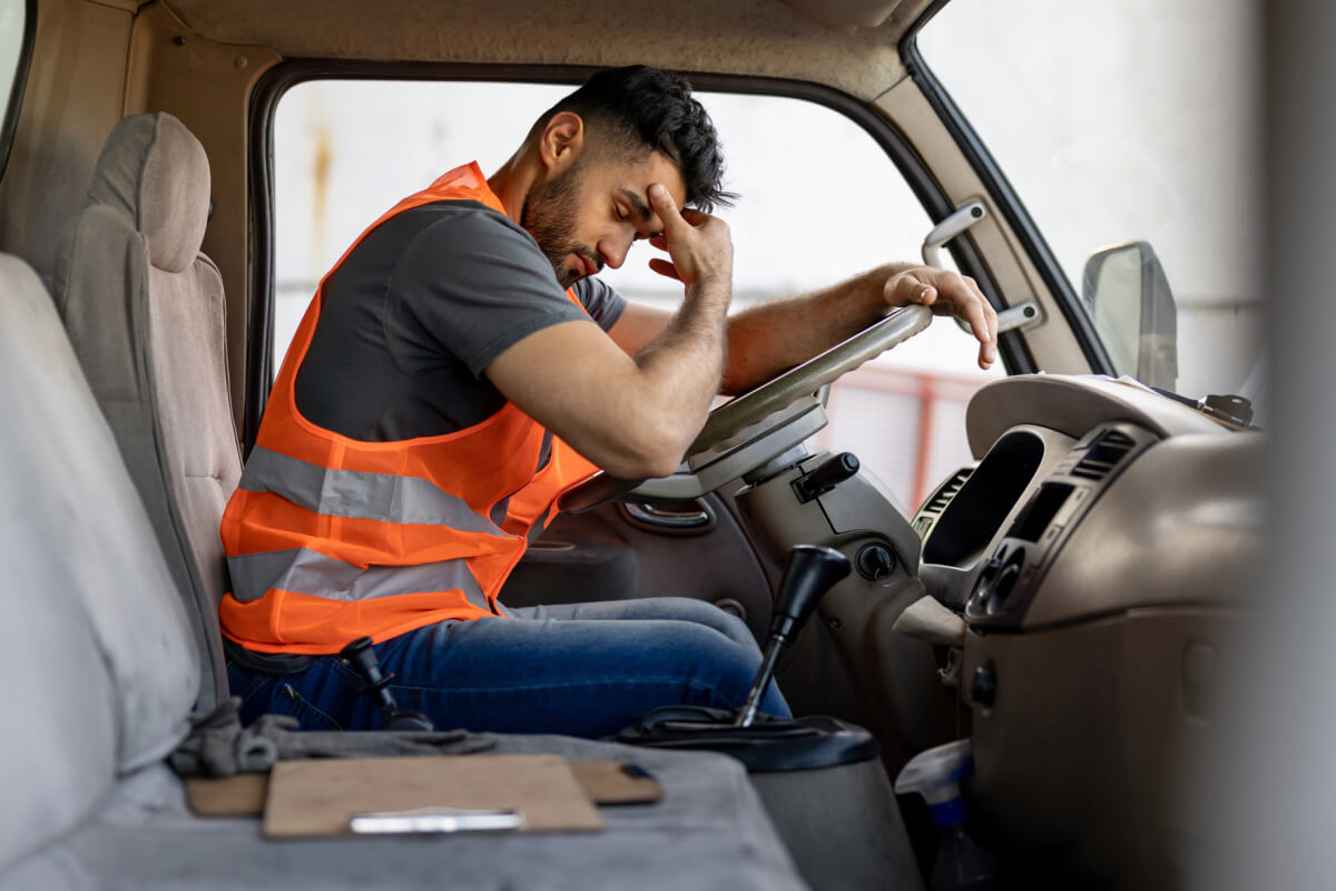 sleepy driver in the cab of a truck
