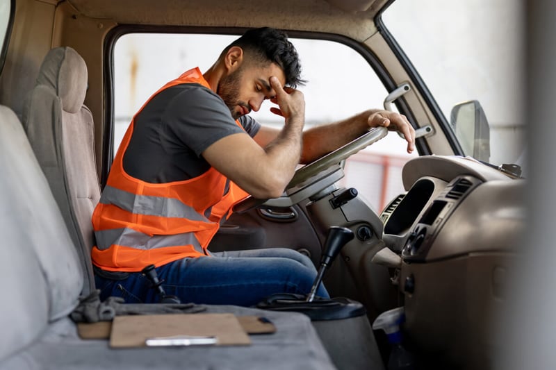 sleepy driver in the cab of a truck