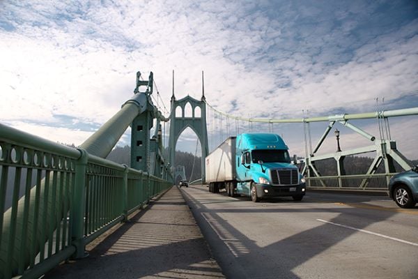 a truck driving over a bridge