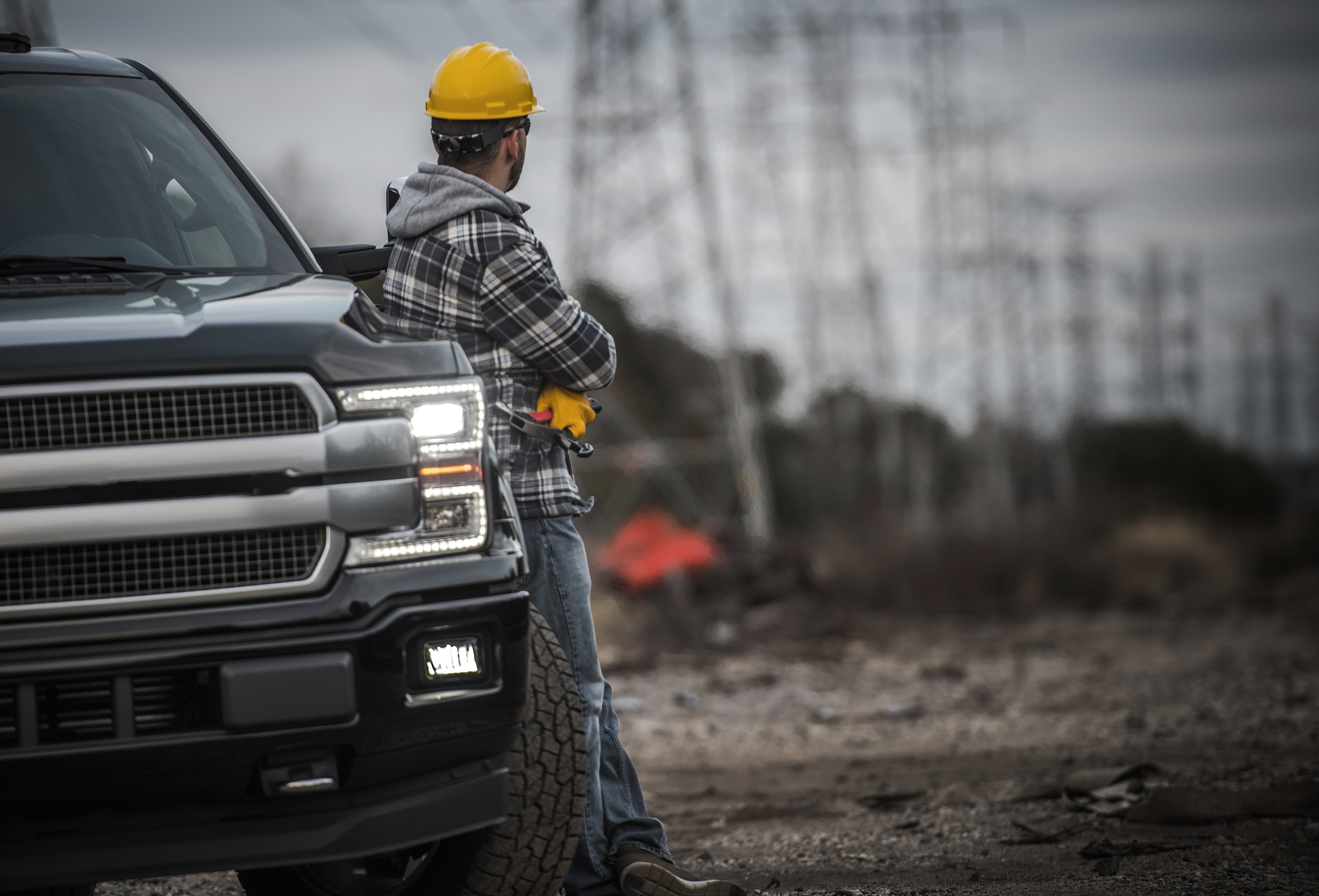 construction worker next to a ute on a site