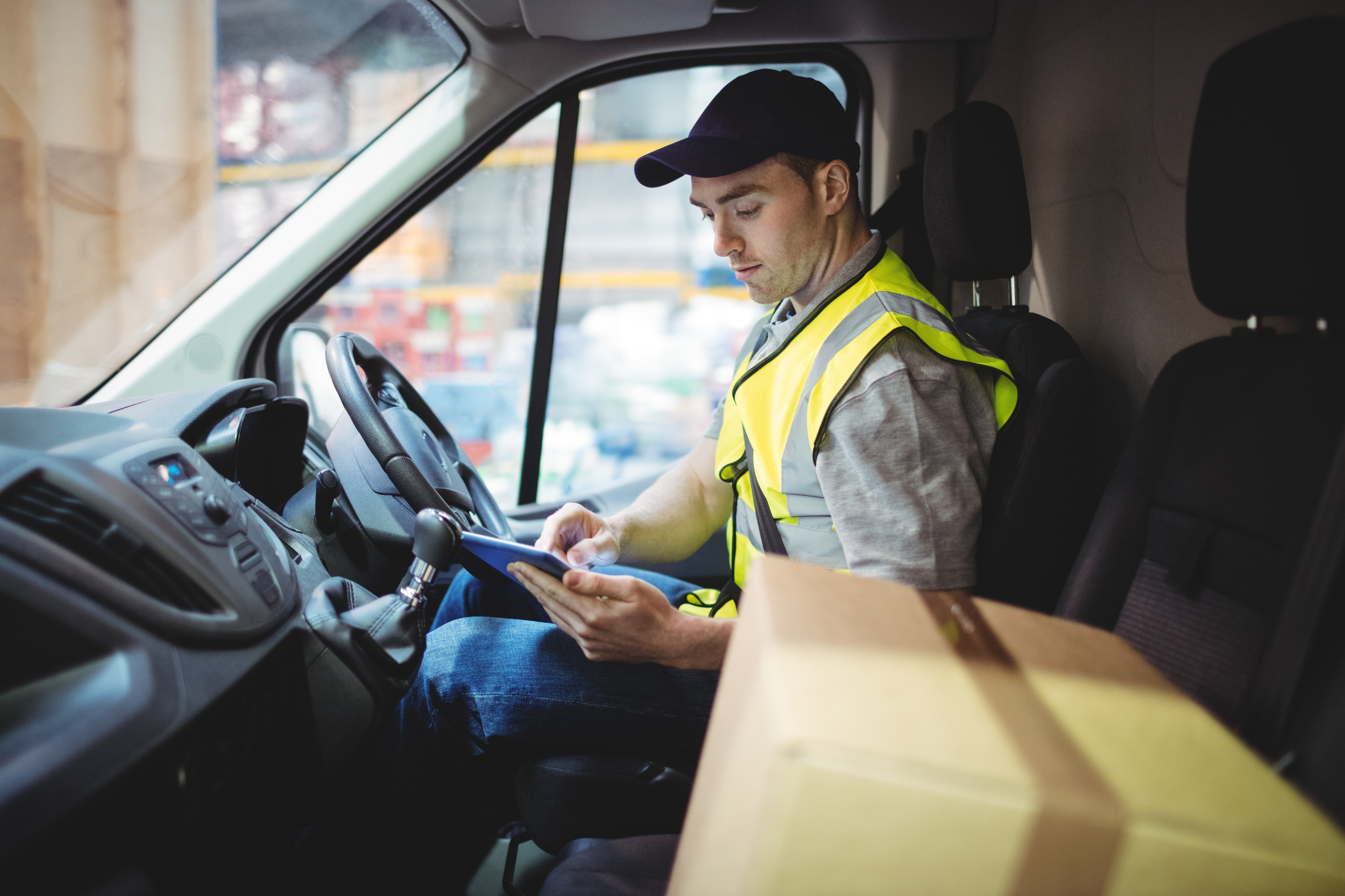 driver using tablet courier van