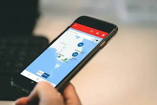 Phone showing MyEROAD Fleet Map with vehicle clusters around Adelaide, Melbourne, Sydney and Brisbane