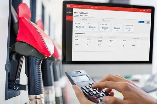 Fuel pump nozzles, a calculator and the MyEROAD Fuel Tax Credit screen on a monitor