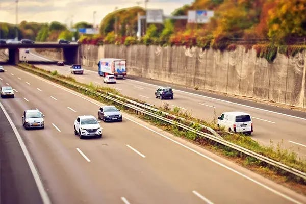 Cars, vans and a truck travelling on a multi-lane motorway