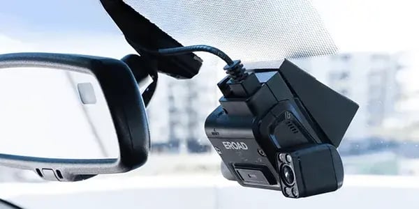 EROAD dashcam with an inward-facing lens mounted on a windscreen beside the rear-view mirror