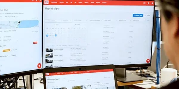 Person viewing EROAD Replay clips of manual trigger events on several screens