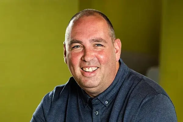 EROAD safety expert Chris Evans smiling, in a dark blue shirt