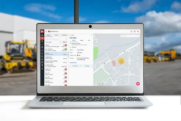 Laptop showing EROAD Where asset tracking on the MyEROAD map, with construction machinery behind