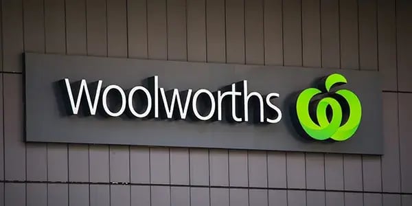 Woolworths logo on a sign on a building wall