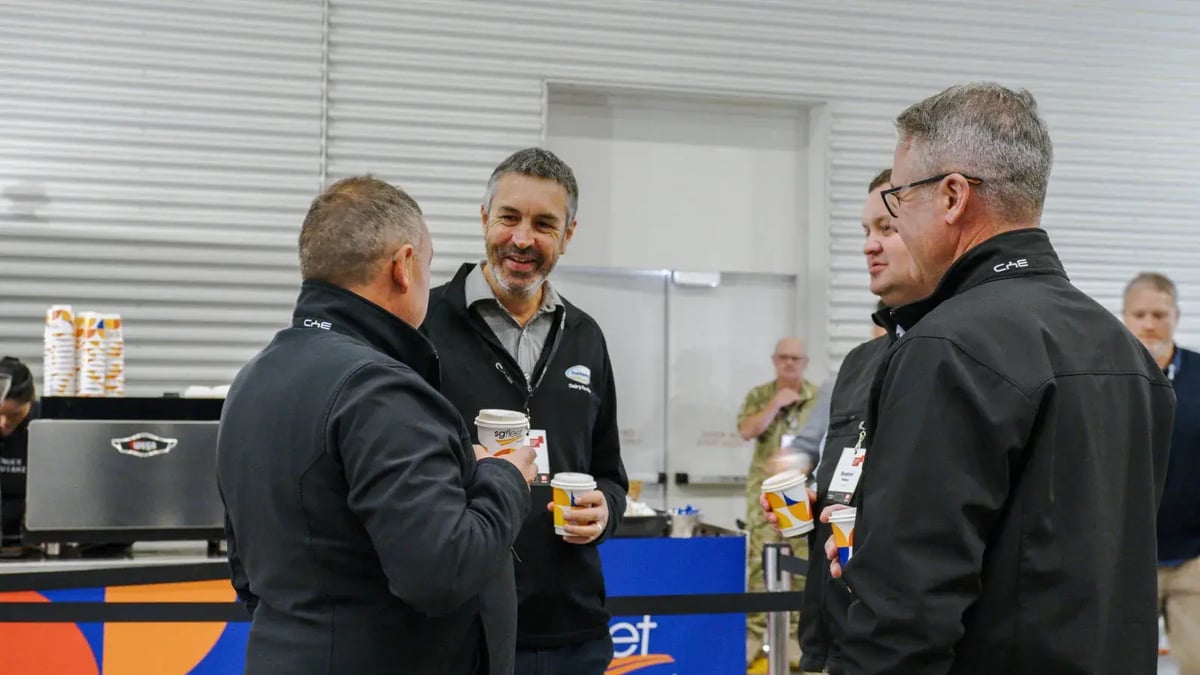 Fleet Day attendees chatting over coffee in an event hall