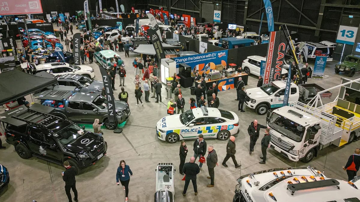 Crowds at EROAD Fleet Day in Hamilton exploring vehicle displays, including a police car and trucks