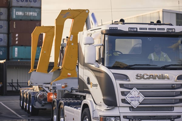 Heavy truck carrying plant on a low loader