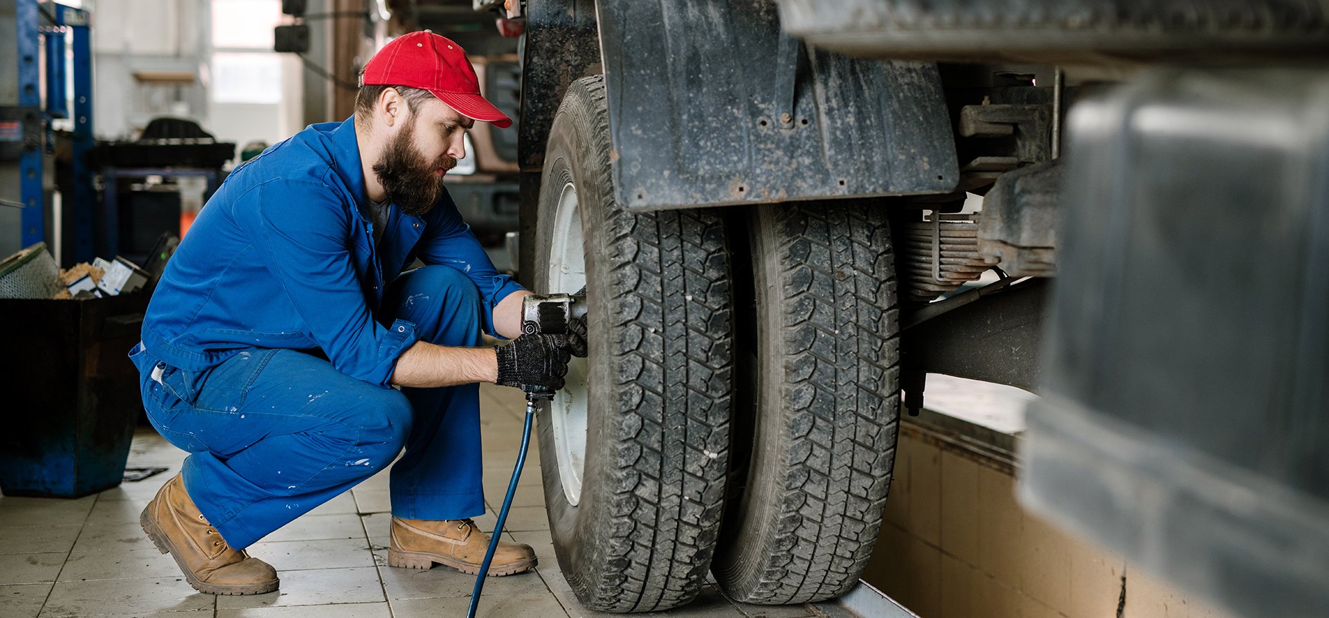 Technician servicing a truck wheel