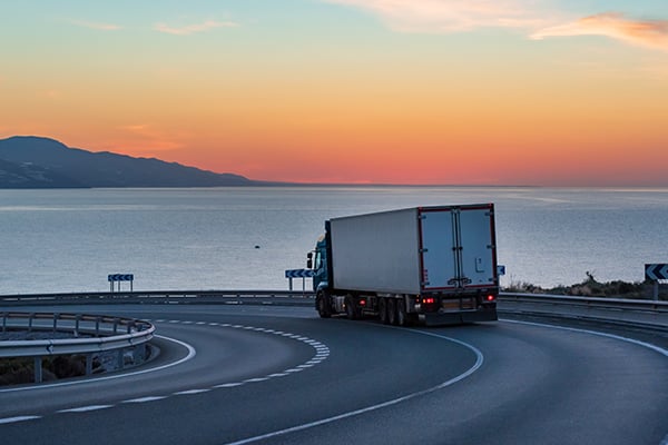 Truck on a coastal highway at dusk