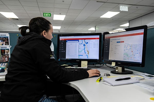 Person in back office reviewing fleet information in MyEROAD