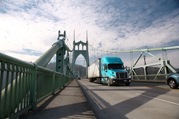 a truck driving over a bridge