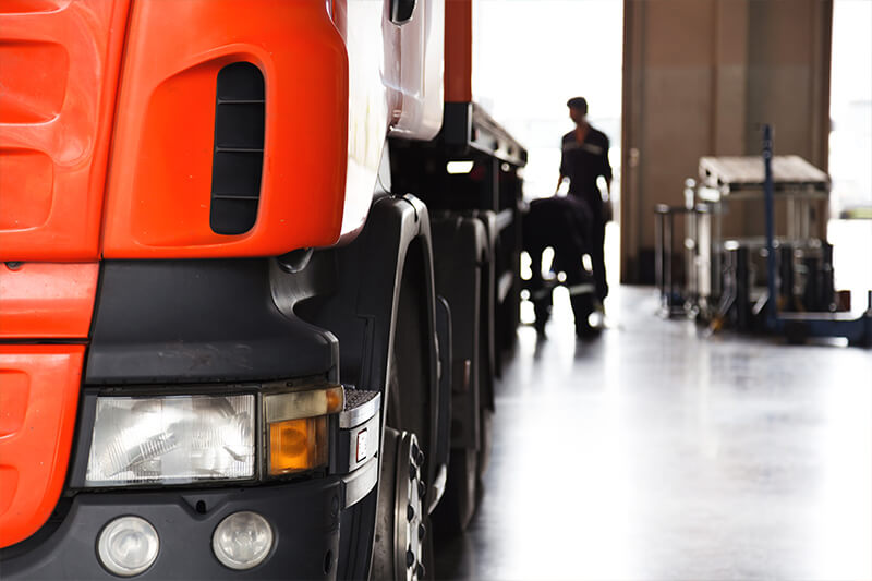 A technician servicing a truck in a workshop