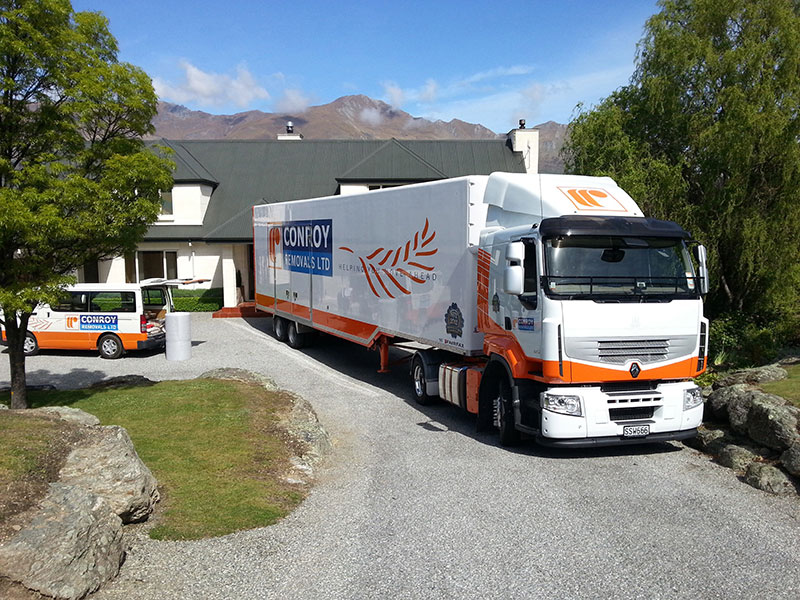 Conroy Removals truck and van outside a house