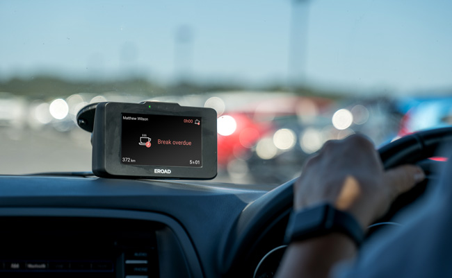 EROAD Ehubo mounted in a vehicle cab showing a break overdue alert