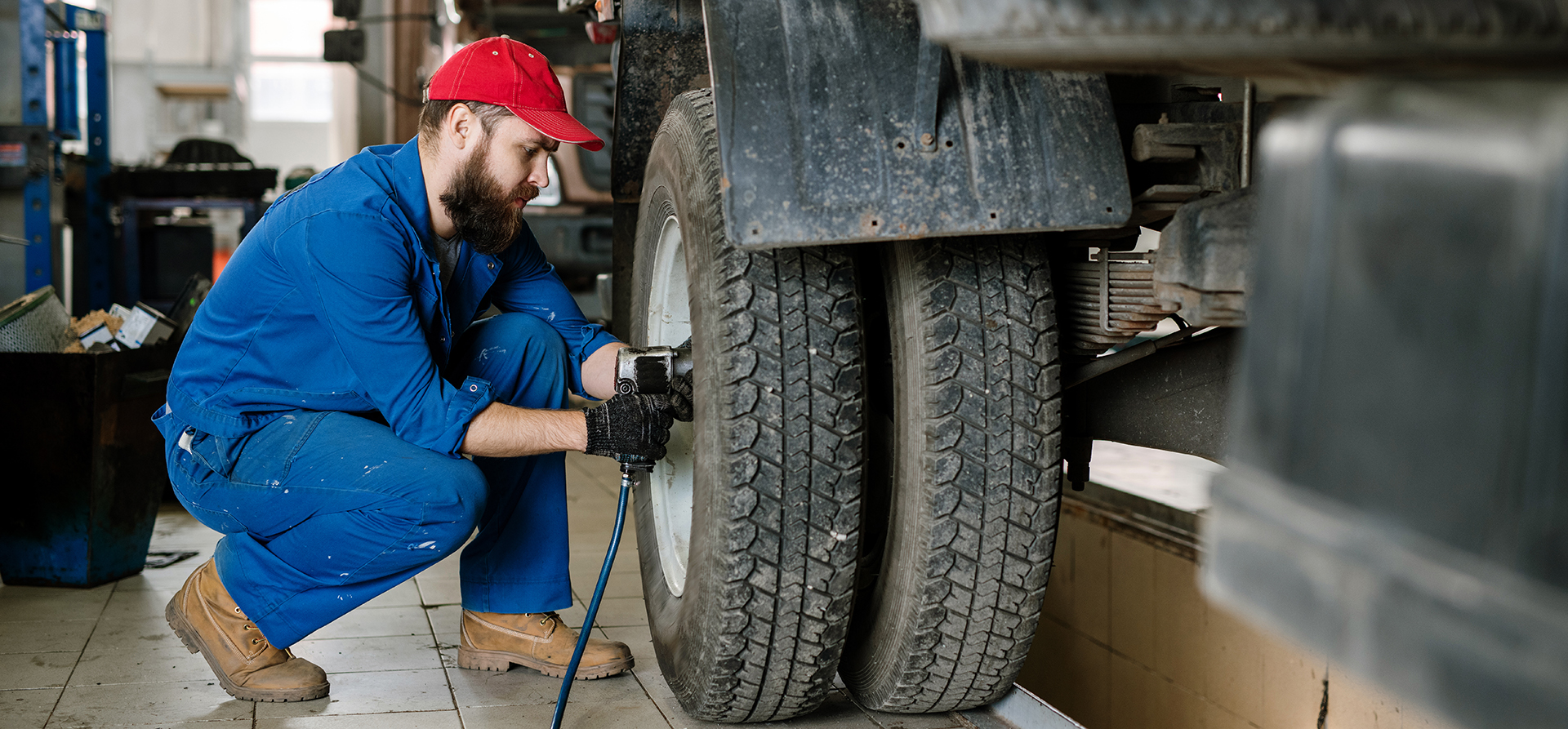 Technician servicing a truck wheel