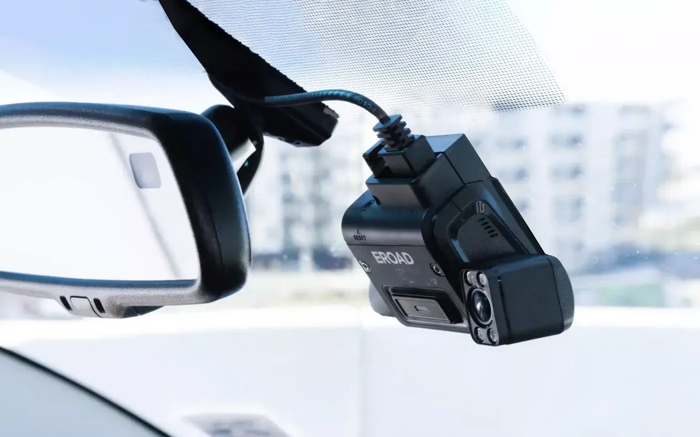 An EROAD Clarity dashcam mounted on the windscreen beside the rear-view mirror