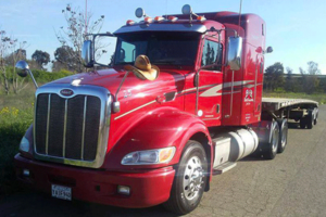 Red B&R Reliable Transport truck with cowboy hat on the hood