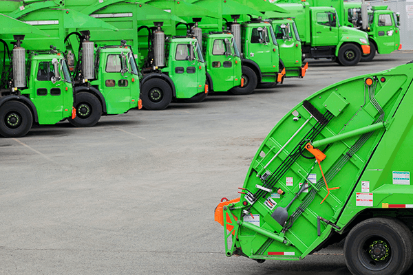 bright green garbage truck fleet